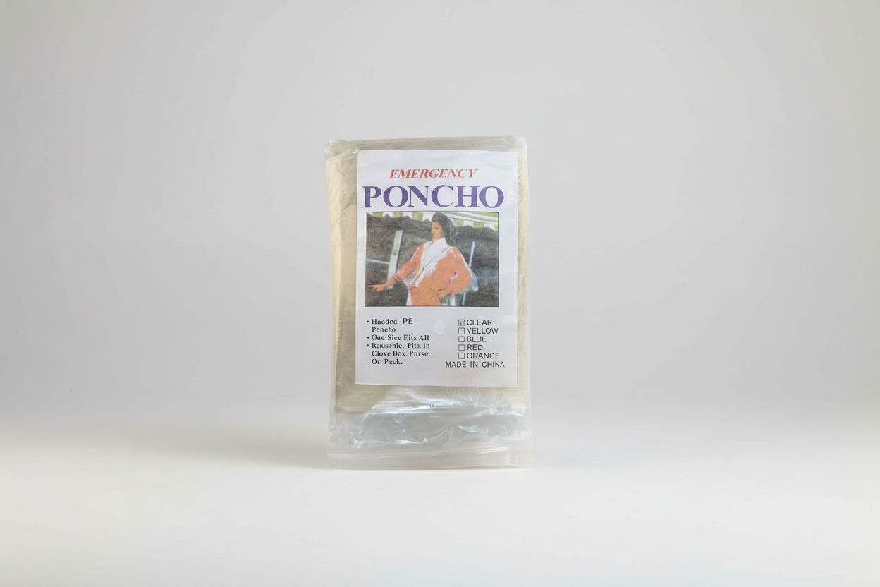 Emergency poncho packaging with a person wearing a poncho on the label.